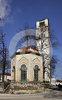 Ottoman tomb and Church of St. Antun Ã¢â¬â clock tower (Sahat kula) in Bihac. Bosnia and Herzegovina photo